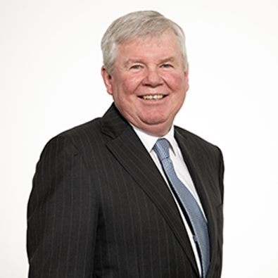 Headshot of RASF Chair Michael Millner in a dark pinstripe suit, light blue shirt, and patterned tie, smiling against a plain background.