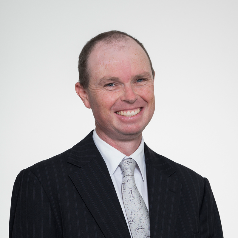Headshot of Compassion Animals Committee Chair Joseph Bryne, wearing a dark pinstripe suit, white shirt, and patterned tie.