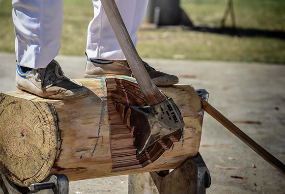 Competitor chopping a log with an axe during the Sydney Royal Woodchop & Sawing Competition.