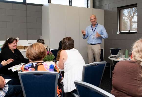 Head of Education Duncan Kendall speaking to a seated group during a Teacher Professional Development session in a classroom.