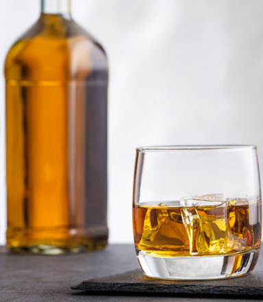 Five glasses of spirits in varying colours lined up for the Sydney Royal Distilled Spirits Show.